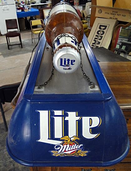 This case of beer cans makes bringing along tasty drinks easy. . Miller lite pool table light